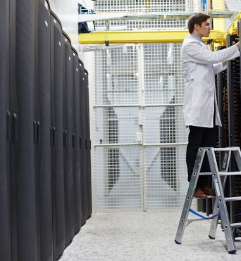 Repairing cryptocurrency system IT staff standing on ladder and repairing storage system in data center